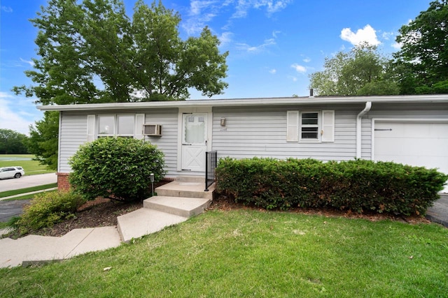 2560 Pebble Valley Rd, Waukesha, WI 53188 - ranch-style home featuring a front yard, a garage, and a wall mounted AC