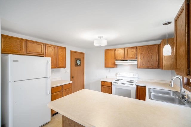 2560 Pebble Valley Rd, Waukesha, WI 53188 - kitchen with white appliances, under cabinet range hood, a peninsula, and light countertops