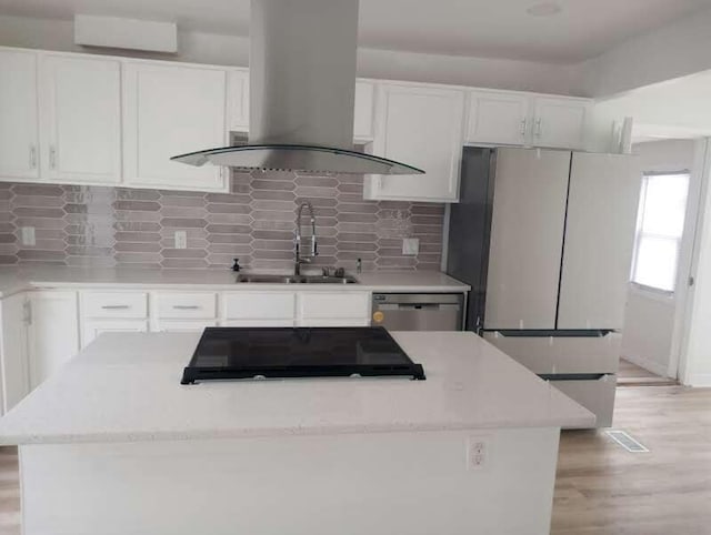 6460 N 91st St, Milwaukee, WI 53224 - kitchen featuring freestanding refrigerator, island exhaust hood, white cabinetry, and stainless steel dishwasher