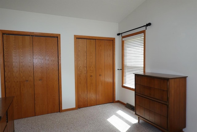 284 White Oak Ave Unit 8, Plover, WI 54467 - unfurnished bedroom with multiple closets and carpet flooring