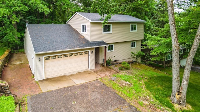 1705 Stark St, Wausau, WI 54403 - view of front of home featuring asphalt driveway, roof with shingles, an attached garage, and a front lawn
