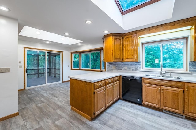 1705 Stark St, Wausau, WI 54403 - kitchen featuring a skylight, black dishwasher, a peninsula, backsplash, and recessed lighting