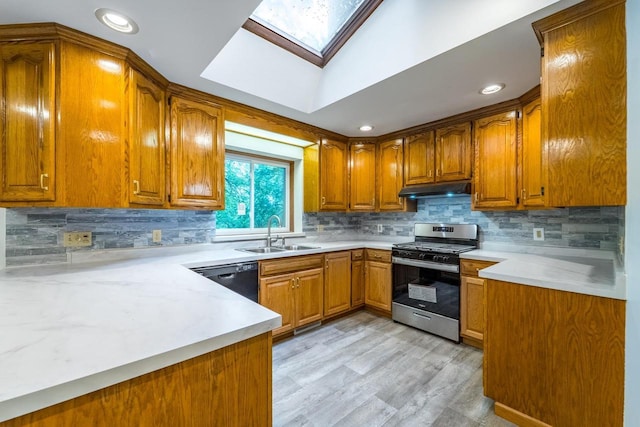 1705 Stark St, Wausau, WI 54403 - kitchen with stainless steel gas range, dishwasher, under cabinet range hood, brown cabinets, and light countertops