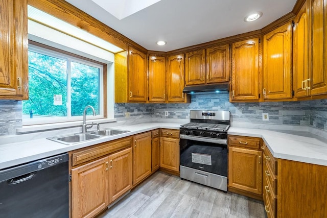 1705 Stark St, Wausau, WI 54403 - kitchen featuring dishwasher, stainless steel range with gas cooktop, under cabinet range hood, brown cabinetry, and recessed lighting