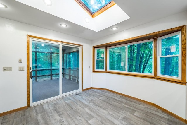 1705 Stark St, Wausau, WI 54403 - empty room with a skylight, wood finished floors, and recessed lighting