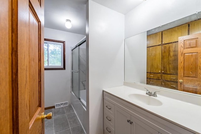 1705 Stark St, Wausau, WI 54403 - bathroom featuring tile patterned flooring, vanity, and bath / shower combo with glass door
