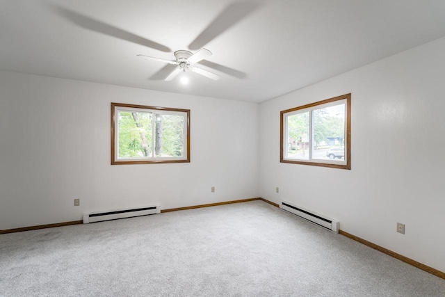 1705 Stark St, Wausau, WI 54403 - spare room with a baseboard heating unit, plenty of natural light, and light colored carpet