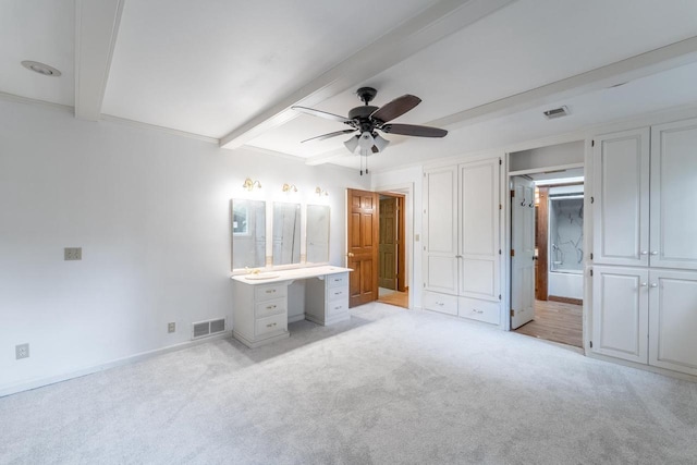1705 Stark St, Wausau, WI 54403 - unfurnished bedroom with beamed ceiling, light carpet, a desk, connected bathroom, and a ceiling fan