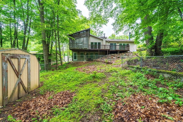 1705 Stark St, Wausau, WI 54403 - back of house with a storage shed, a wooden deck, a fenced backyard, and a sunroom