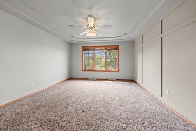 1106 Lake Largo Dr, Green Bay, WI 54311 - unfurnished room with carpet, a tray ceiling, and ceiling fan