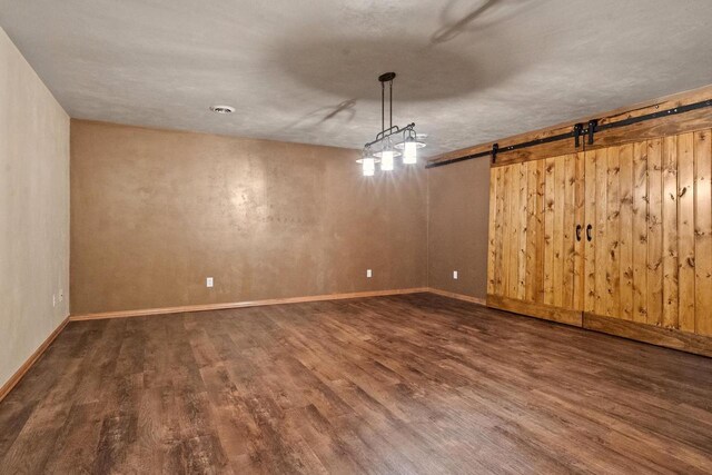 1106 Lake Largo Dr, Green Bay, WI 54311 - spare room featuring wood finished floors and a barn door