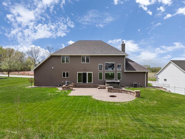 1106 Lake Largo Dr, Green Bay, WI 54311 - rear view of house featuring a patio area, a fire pit, a chimney, and a hot tub