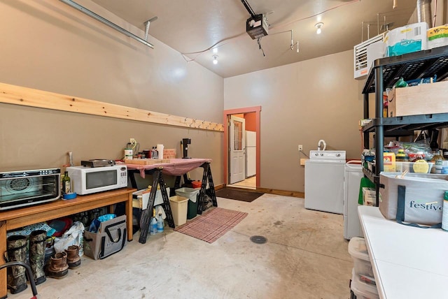 N5730 Parkway Rd, Pound, WI 54161 - garage featuring freestanding refrigerator, a garage door opener, and washing machine and dryer