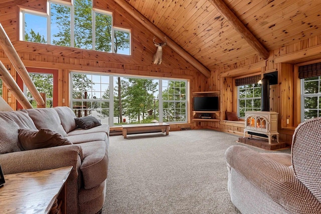 N5730 Parkway Rd, Pound, WI 54161 - living room featuring a wood stove, wooden walls, high vaulted ceiling, carpet floors, and a wood ceiling with exposed beams