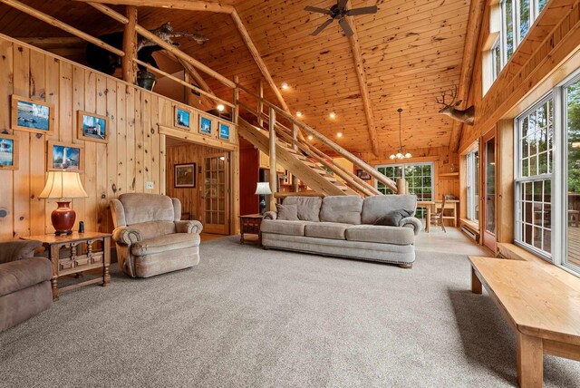 N5730 Parkway Rd, Pound, WI 54161 - carpeted living area with wooden walls, high vaulted ceiling, wood ceiling, plenty of natural light, and a ceiling fan