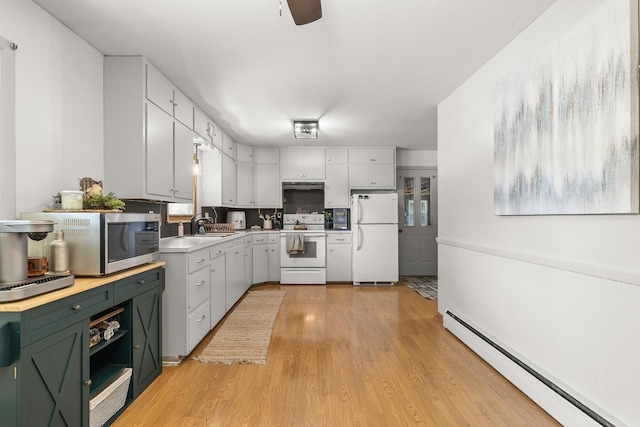 551 Market Ave, Port Edwards, WI 54469 - kitchen featuring white appliances, baseboard heating, light wood-style floors, light countertops, and a ceiling fan