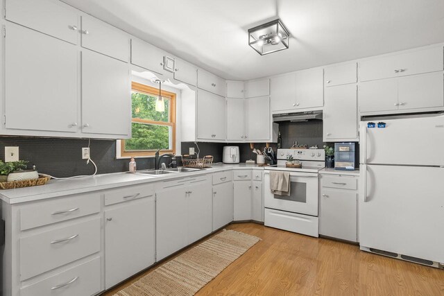 551 Market Ave, Port Edwards, WI 54469 - kitchen with white appliances, under cabinet range hood, tasteful backsplash, light countertops, and white cabinetry