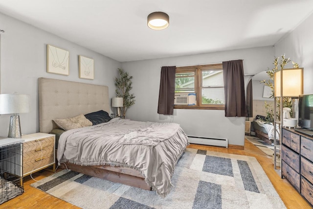 551 Market Ave, Port Edwards, WI 54469 - bedroom with a baseboard heating unit, light wood-style floors, and cooling unit