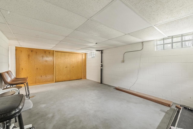 551 Market Ave, Port Edwards, WI 54469 - basement featuring concrete block wall, a drop ceiling, and wooden walls