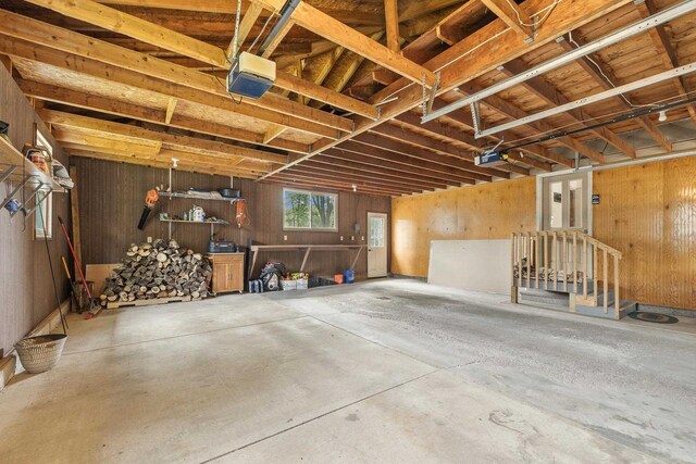 551 Market Ave, Port Edwards, WI 54469 - garage featuring a garage door opener and wood walls