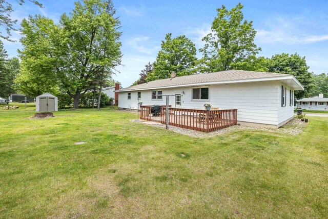 551 Market Ave, Port Edwards, WI 54469 - back of property with a storage unit, a wooden deck, and a lawn