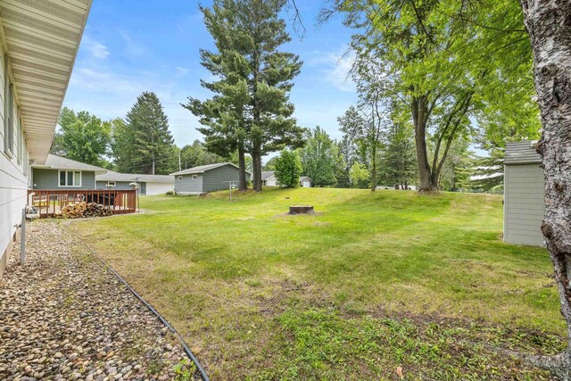 551 Market Ave, Port Edwards, WI 54469 - view of green lawn with an outdoor fire pit and a deck