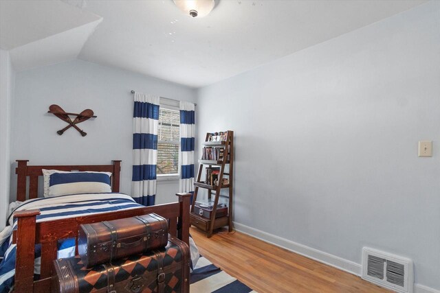 6738 W Monona Pl, West Allis, WI 53219 - bedroom featuring wood finished floors and vaulted ceiling