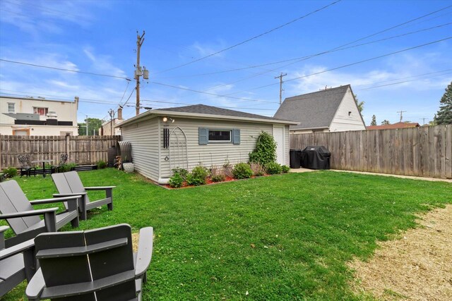 6738 W Monona Pl, West Allis, WI 53219 - back of house featuring a fenced backyard and an outdoor structure