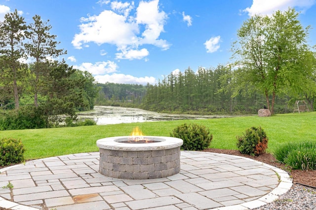 W356N6752 E Stonewood Dr, Oconomowoc, WI 53066 - view of patio featuring a fire pit, a water view, and a forest view