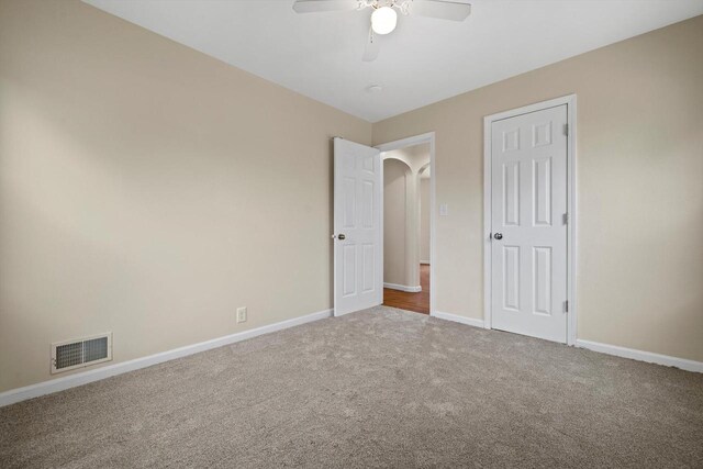 2225 Shoop St, Racine, WI 53404 - unfurnished bedroom with carpet flooring, arched walkways, and a ceiling fan