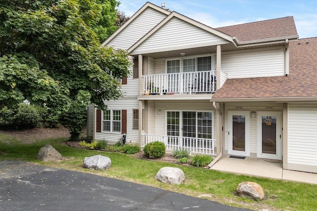 1819 Sumac Ct Unit A, Grafton, WI 53024 - multi unit property featuring a balcony, a shingled roof, and a front lawn