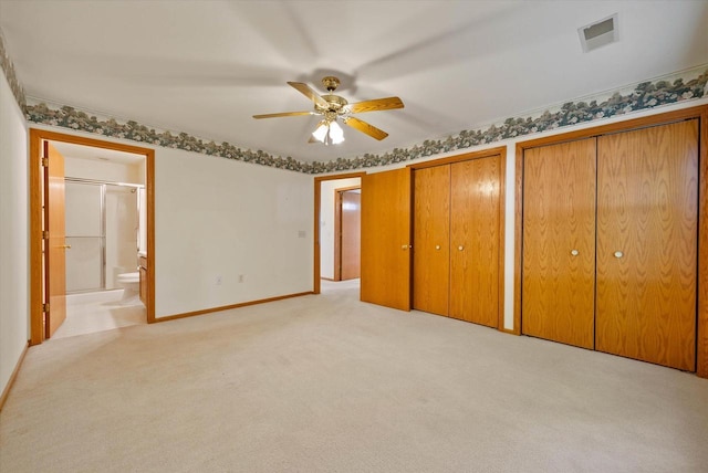 1819 Sumac Ct Unit A, Grafton, WI 53024 - unfurnished bedroom featuring light colored carpet, two closets, ensuite bath, and a ceiling fan
