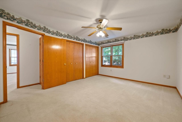 1819 Sumac Ct Unit A, Grafton, WI 53024 - unfurnished bedroom featuring light colored carpet, two closets, and ceiling fan