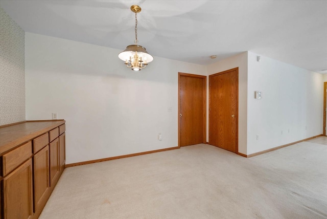 1819 Sumac Ct Unit A, Grafton, WI 53024 - unfurnished dining area featuring light carpet and a chandelier