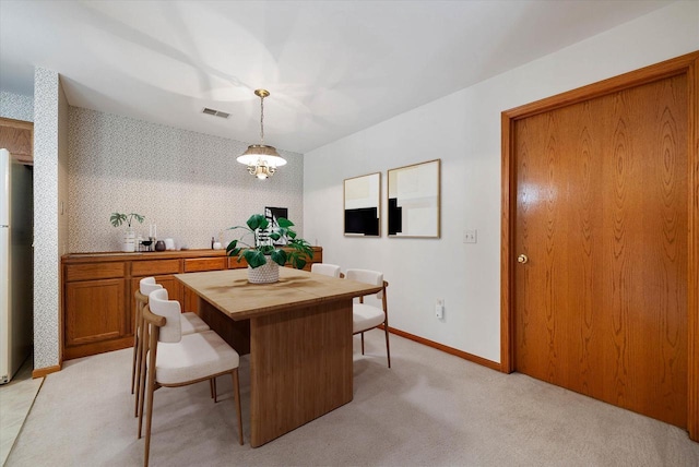 1819 Sumac Ct Unit A, Grafton, WI 53024 - dining area featuring wallpapered walls, light carpet, and a chandelier