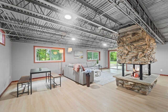 4326 Taylor Ave, Mount Pleasant, WI 53405 - living area featuring wood finished floors, a stone fireplace, and plenty of natural light