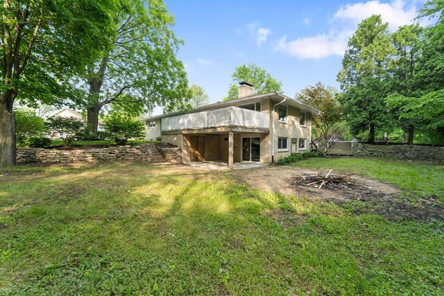 4326 Taylor Ave, Mount Pleasant, WI 53405 - rear view of house with a chimney, a deck, a yard, and stucco siding