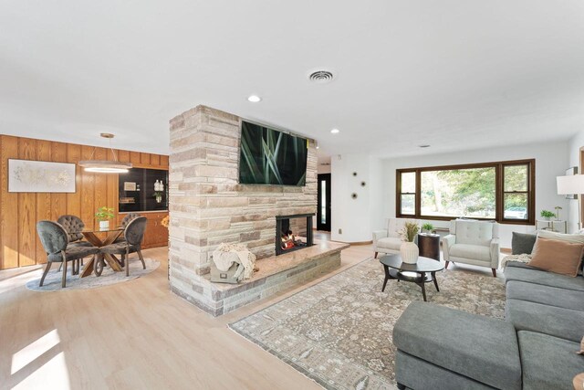 4326 Taylor Ave, Mount Pleasant, WI 53405 - living area featuring wood finished floors, a stone fireplace, and wooden walls
