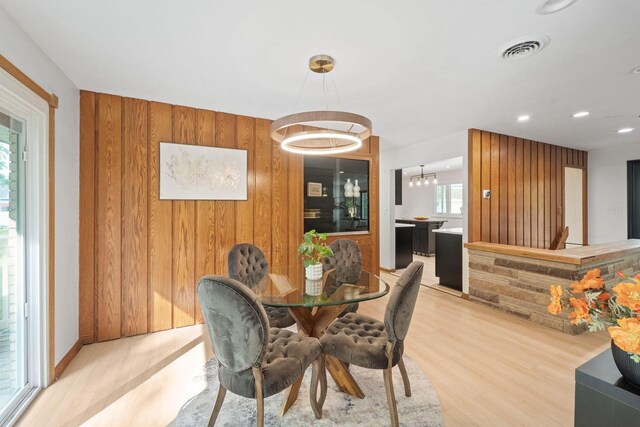 4326 Taylor Ave, Mount Pleasant, WI 53405 - dining room with wood walls, light wood-type flooring, recessed lighting, and a chandelier
