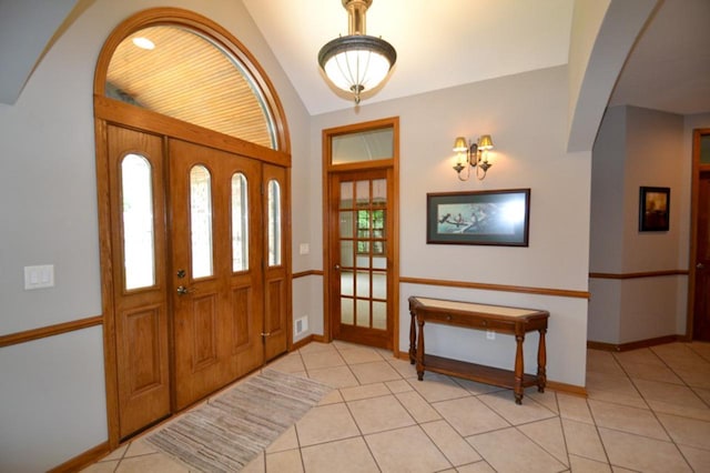 551 Bayberry Ln, Slinger, WI 53086 - entryway with light tile patterned floors, lofted ceiling, and arched walkways