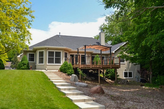 551 Bayberry Ln, Slinger, WI 53086 - rear view of property with a deck, a yard, and a chimney