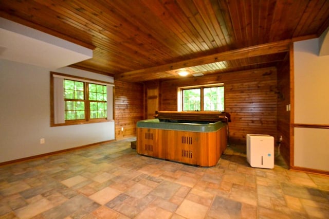 551 Bayberry Ln, Slinger, WI 53086 - kitchen with wood walls, light stone finish flooring, wood ceiling, brown cabinetry, and a peninsula
