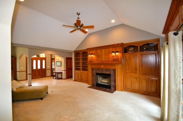 551 Bayberry Ln, Slinger, WI 53086 - unfurnished living room featuring arched walkways, a ceiling fan, light colored carpet, a fireplace, and recessed lighting