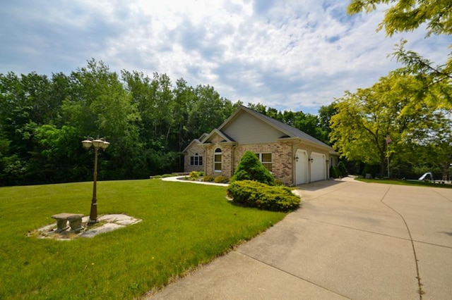 551 Bayberry Ln, Slinger, WI 53086 - view of home's exterior with concrete driveway, a garage, a lawn, and brick siding