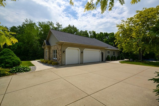 551 Bayberry Ln, Slinger, WI 53086 - view of side of home with an attached garage and concrete driveway