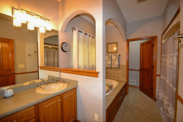 551 Bayberry Ln, Slinger, WI 53086 - bathroom featuring vanity, tile patterned floors, and a bath