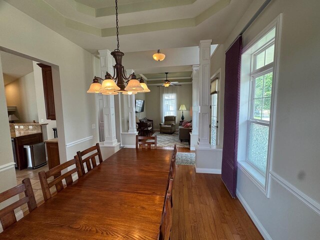 4126 Westerfield Ln, Madison, WI 53704 - dining space with ornate columns, a ceiling fan, wood finished floors, and a raised ceiling