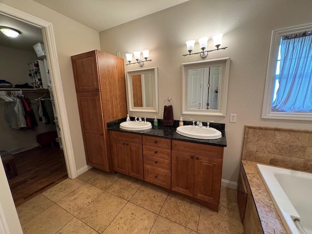 4126 Westerfield Ln, Madison, WI 53704 - full bath featuring double vanity, a bath, a walk in closet, and tile patterned flooring