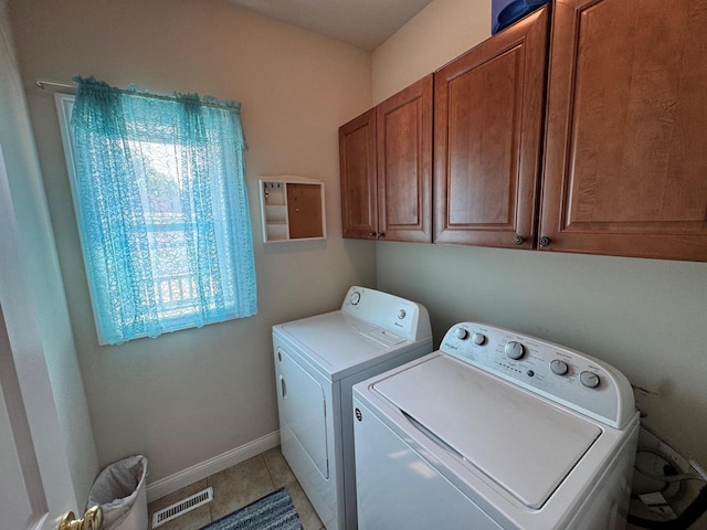 4126 Westerfield Ln, Madison, WI 53704 - laundry area featuring independent washer and dryer, cabinet space, and light tile patterned flooring