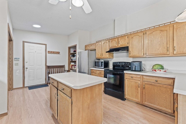 12129 221st Ave, Bristol, WI 53104 - kitchen featuring appliances with stainless steel finishes, light wood-style floors, under cabinet range hood, a center island, and ceiling fan